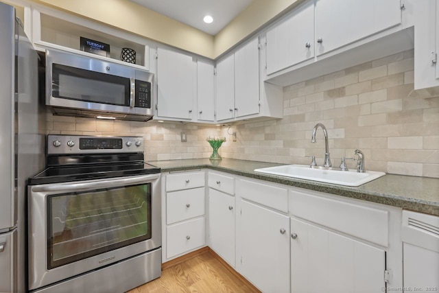 33 Raven Rd, Trumbull, CT 06611 - kitchen with stainless steel appliances, a sink, and white cabinetry