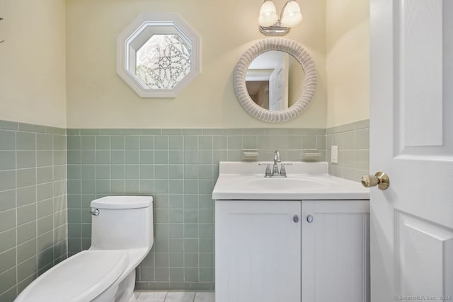 33 Raven Rd, Trumbull, CT 06611 - bathroom featuring tile walls, vanity, toilet, wainscoting, and tile patterned floors