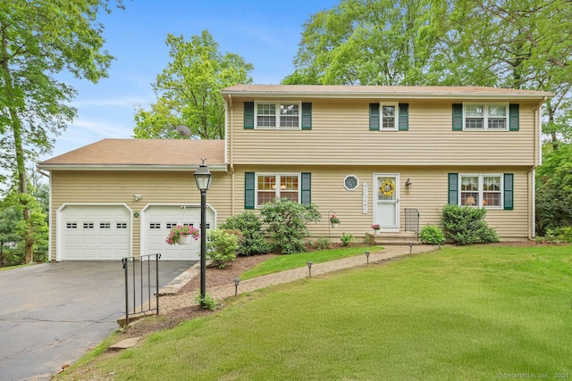 33 Raven Rd, Trumbull, CT 06611 - colonial-style house with asphalt driveway, a front yard, and an attached garage