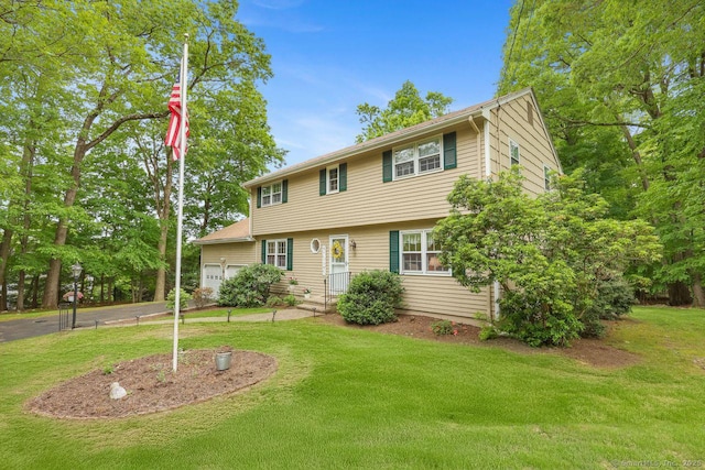 33 Raven Rd, Trumbull, CT 06611 - colonial-style house featuring a front yard and an attached garage