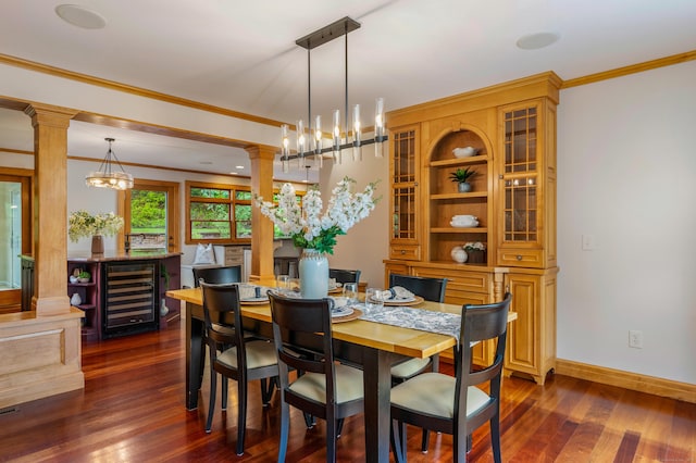 607 Tolland Stage Rd, Tolland, CT 06084 - dining area with beverage cooler, dark wood finished floors, a chandelier, crown molding, and decorative columns
