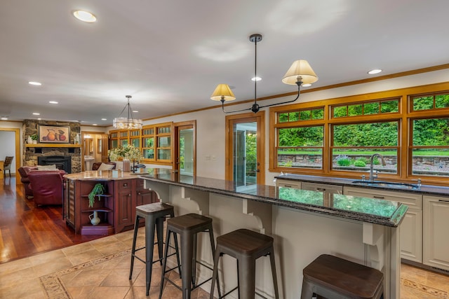607 Tolland Stage Rd, Tolland, CT 06084 - kitchen with a sink, a kitchen island, open shelves, recessed lighting, and dark stone counters