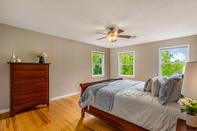 607 Tolland Stage Rd, Tolland, CT 06084 - bedroom with baseboards, light wood-style floors, and a ceiling fan