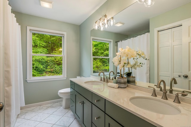 607 Tolland Stage Rd, Tolland, CT 06084 - full bath with double vanity, toilet, marble finish floors, and baseboards