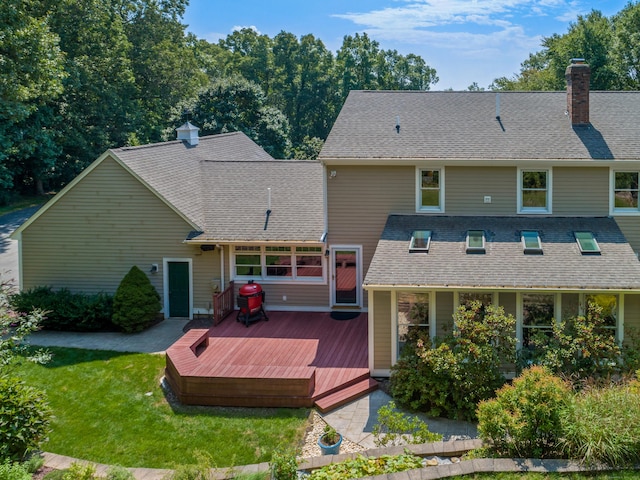 607 Tolland Stage Rd, Tolland, CT 06084 - back of property with a deck, a chimney, a yard, and roof with shingles