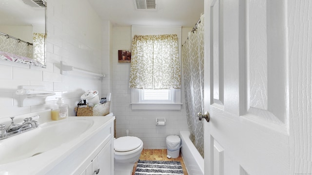 32 Lawrence Ave, Milford, CT 06460 - full bathroom with tile walls, vanity, toilet, tile patterned flooring, and a shower with curtain