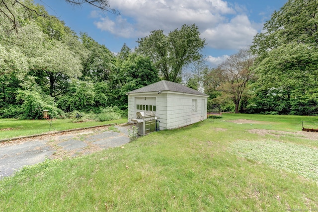 9 Jennings St, Griswold, CT 06351 - view of green lawn with a detached garage, an outbuilding, and a forest view