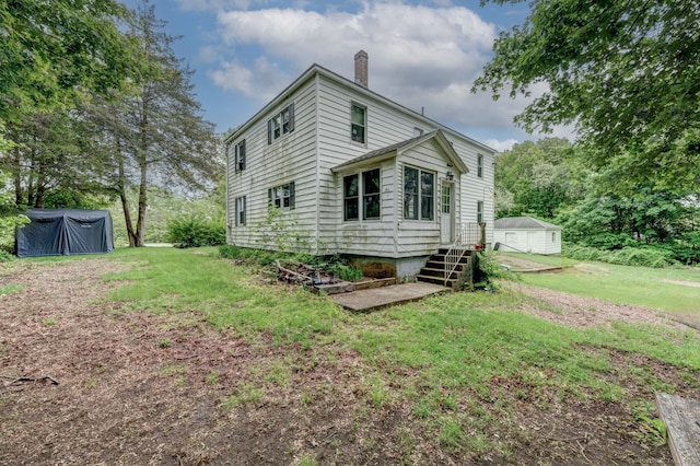 9 Jennings St, Griswold, CT 06351 - view of home's exterior featuring a chimney and a lawn