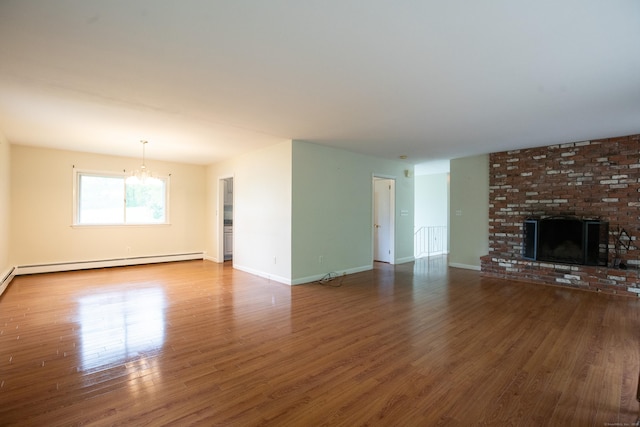 21 Elizabeth St, Trumbull, CT 06611 - unfurnished living room with a chandelier, wood finished floors, a baseboard radiator, and a brick fireplace