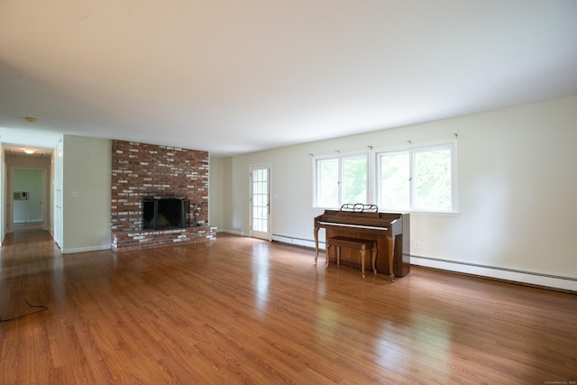 21 Elizabeth St, Trumbull, CT 06611 - unfurnished living room featuring a baseboard heating unit, wood finished floors, a baseboard radiator, and a brick fireplace