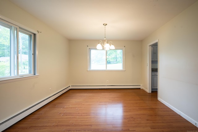 21 Elizabeth St, Trumbull, CT 06611 - empty room featuring plenty of natural light, a baseboard heating unit, a chandelier, and wood finished floors