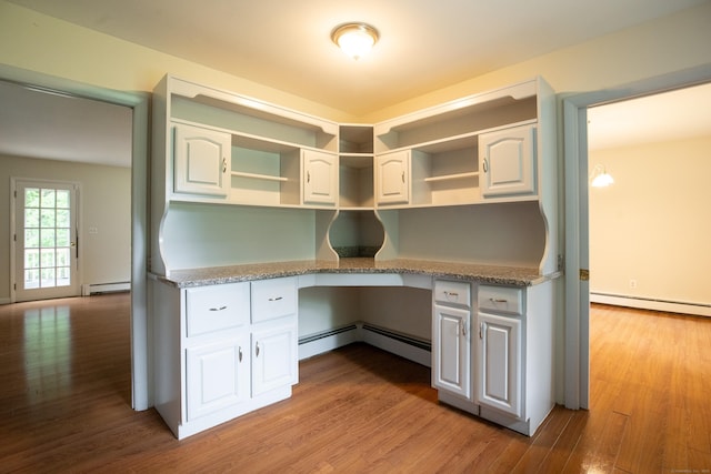 21 Elizabeth St, Trumbull, CT 06611 - kitchen featuring a baseboard heating unit, wood finished floors, light stone countertops, and white cabinetry
