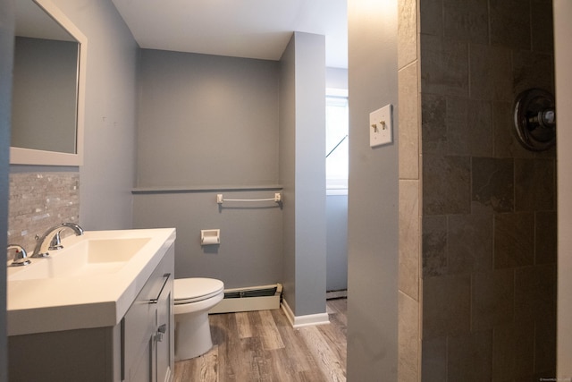 21 Elizabeth St, Trumbull, CT 06611 - bathroom featuring a baseboard radiator, wood finished floors, toilet, vanity, and tiled shower