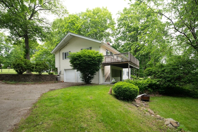 21 Elizabeth St, Trumbull, CT 06611 - view of front of property with asphalt driveway, a wooden deck, a front lawn, and a garage