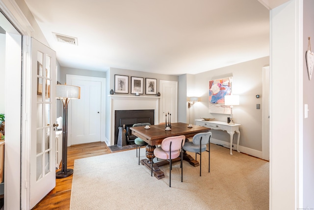 23 Goodsell Hill Rd, Redding, CT 06896 - dining area featuring a fireplace with flush hearth and wood finished floors