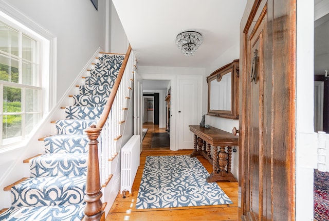 23 Goodsell Hill Rd, Redding, CT 06896 - foyer with radiator, stairway, and light wood-style flooring