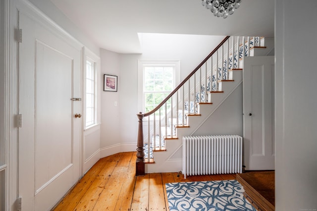 23 Goodsell Hill Rd, Redding, CT 06896 - entrance foyer with radiator, light wood-style flooring, and stairway