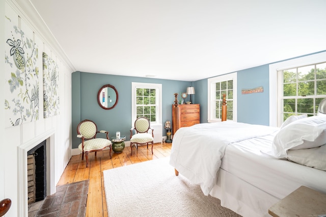 23 Goodsell Hill Rd, Redding, CT 06896 - bedroom with hardwood / wood-style flooring, radiator, and a brick fireplace