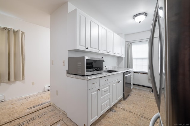 510 S St S, Bristol, CT 06010 - kitchen with stainless steel appliances, white cabinets, a baseboard heating unit, light countertops, and a sink