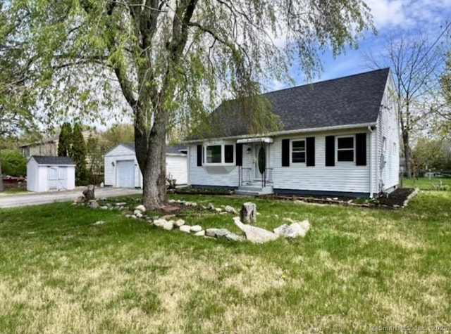 15 S Pine St, Plainfield, CT 06374 - view of front of property featuring a front yard, driveway, a detached garage, and a shingled roof