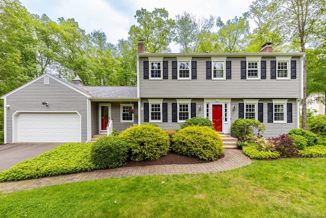 16 Darley Dr, Hamden, CT 06518 - colonial home featuring a chimney, a garage, driveway, and a front lawn
