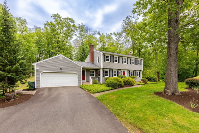 16 Darley Dr, Hamden, CT 06518 - colonial-style house with a chimney, driveway, a garage, and a front lawn