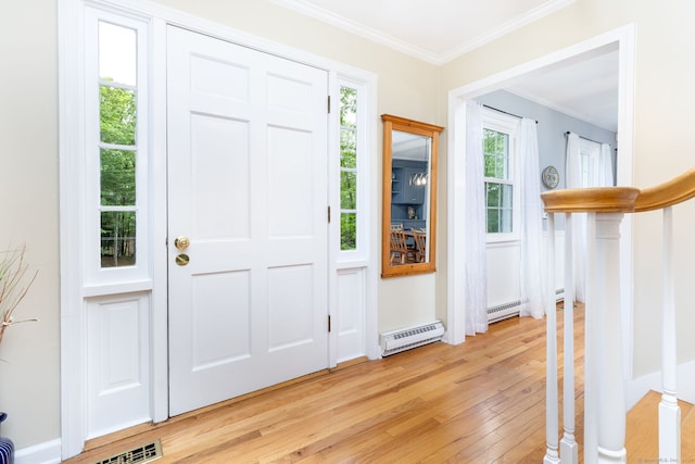 16 Darley Dr, Hamden, CT 06518 - foyer entrance with light wood-style floors, a baseboard radiator, crown molding, and stairway