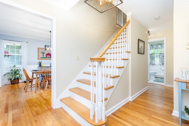16 Darley Dr, Hamden, CT 06518 - stairway featuring wood-type flooring, crown molding, a chandelier, and baseboards