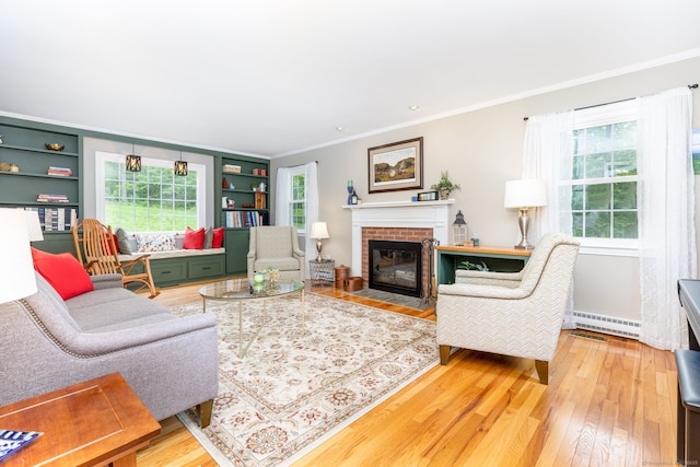 16 Darley Dr, Hamden, CT 06518 - living area with crown molding, hardwood / wood-style floors, healthy amount of natural light, and a brick fireplace