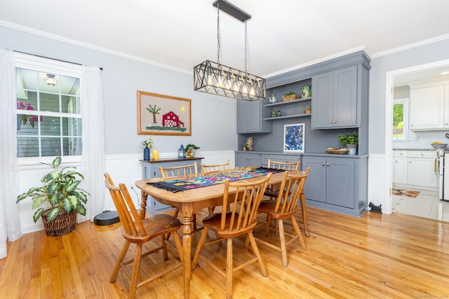16 Darley Dr, Hamden, CT 06518 - dining space with ornamental molding, light wood-style floors, wainscoting, and a decorative wall
