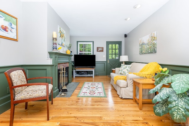 16 Darley Dr, Hamden, CT 06518 - living area with a decorative wall, a fireplace, light wood finished floors, wainscoting, and recessed lighting