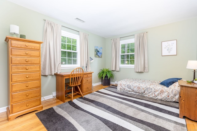 16 Darley Dr, Hamden, CT 06518 - bedroom featuring light wood-style floors, multiple windows, baseboards, and an office area