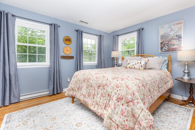 16 Darley Dr, Hamden, CT 06518 - bedroom featuring a baseboard heating unit, wood finished floors, and baseboards