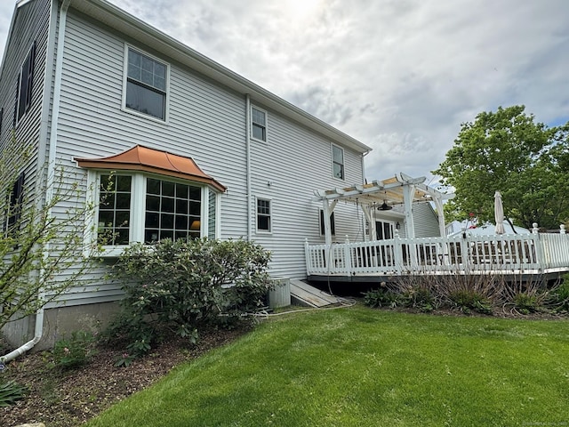 16 Jeremy River Dr, Colchester, CT 06415 - rear view of house with a pergola, a wooden deck, and a lawn