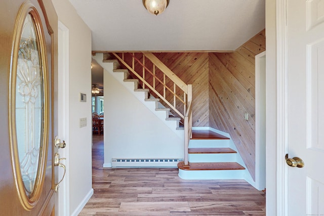 54 Flax Hill Rd, Brookfield, CT 06804 - foyer entrance with a baseboard heating unit, stairway, wood finished floors, wooden walls, and baseboards