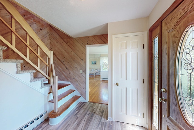 54 Flax Hill Rd, Brookfield, CT 06804 - foyer featuring baseboard heating, stairs, wooden walls, and light wood-type flooring