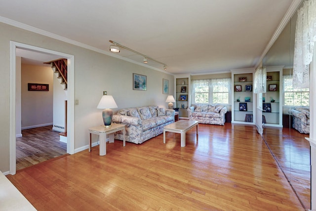 54 Flax Hill Rd, Brookfield, CT 06804 - living area with light wood finished floors, stairway, crown molding, built in shelves, and track lighting