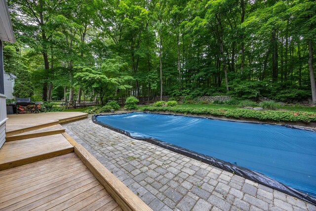 50 Stonehedge Ln S, Guilford, CT 06437 - view of swimming pool featuring a covered pool, a wooden deck, and a patio