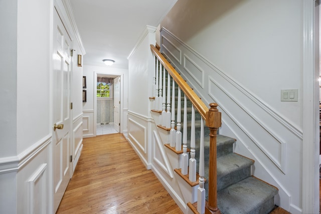 50 Stonehedge Ln S, Guilford, CT 06437 - stairway featuring a decorative wall, ornamental molding, wood finished floors, and wainscoting