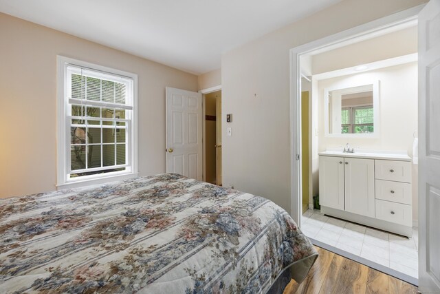 50 Stonehedge Ln S, Guilford, CT 06437 - bedroom with multiple windows, light wood-type flooring, and a sink