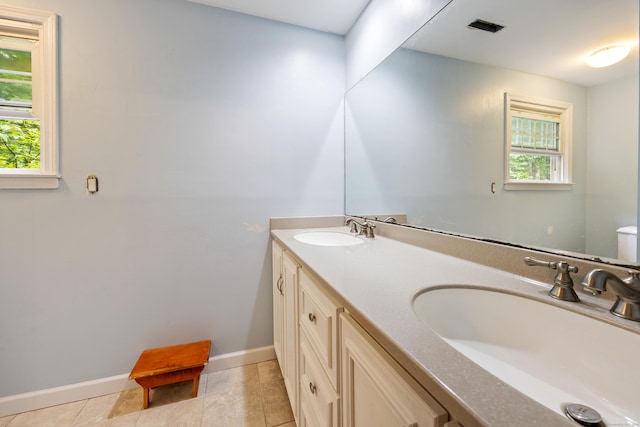 50 Stonehedge Ln S, Guilford, CT 06437 - bathroom featuring plenty of natural light, double vanity, toilet, and baseboards