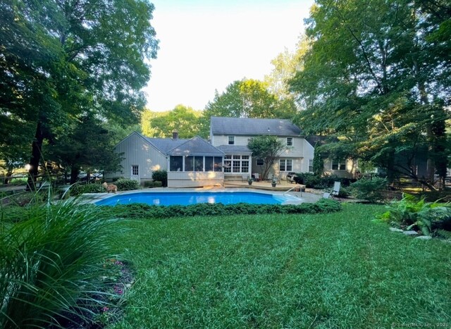 50 Stonehedge Ln S, Guilford, CT 06437 - back of house featuring a sunroom, an outdoor pool, and a yard