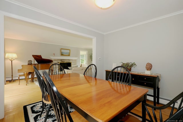 33 Preston Rd, Trumbull, CT 06611 - dining space with crown molding, light wood finished floors, and a stone fireplace