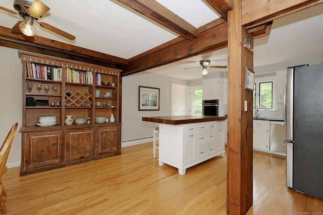 33 Preston Rd, Trumbull, CT 06611 - kitchen featuring appliances with stainless steel finishes, ceiling fan, white cabinetry, light wood-style floors, and beamed ceiling