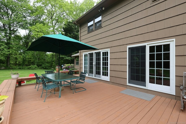 33 Preston Rd, Trumbull, CT 06611 - wooden deck with outdoor dining area, a lawn, and view of scattered trees
