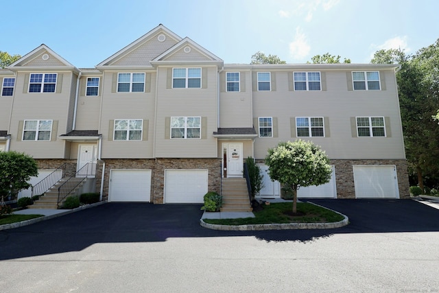23 Riverview Ct Unit 23, Brookfield, CT 06804 - view of front of home featuring driveway, a garage, and stone siding