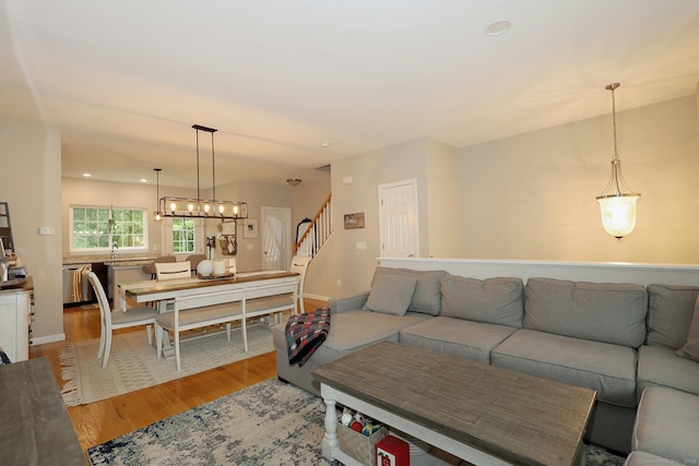 23 Riverview Ct Unit 23, Brookfield, CT 06804 - living room featuring light wood-style floors, stairway, a chandelier, and baseboards