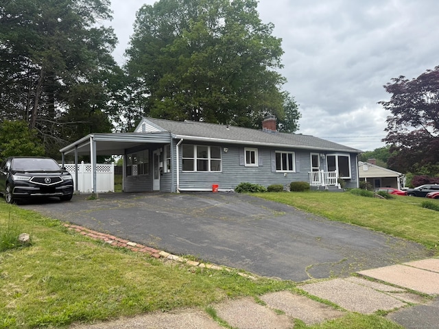 129 Monroe St, East Hartford, CT 06118 - ranch-style home with a front yard, asphalt driveway, a chimney, and an attached carport
