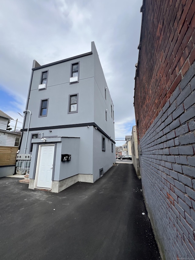 49 Hill St, Waterbury, CT 06704 - view of side of property with stucco siding