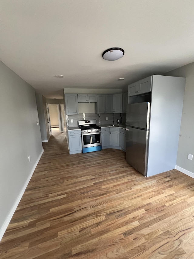 49 Hill St, Waterbury, CT 06704 - kitchen featuring appliances with stainless steel finishes, gray cabinets, baseboards, wood finished floors, and light countertops